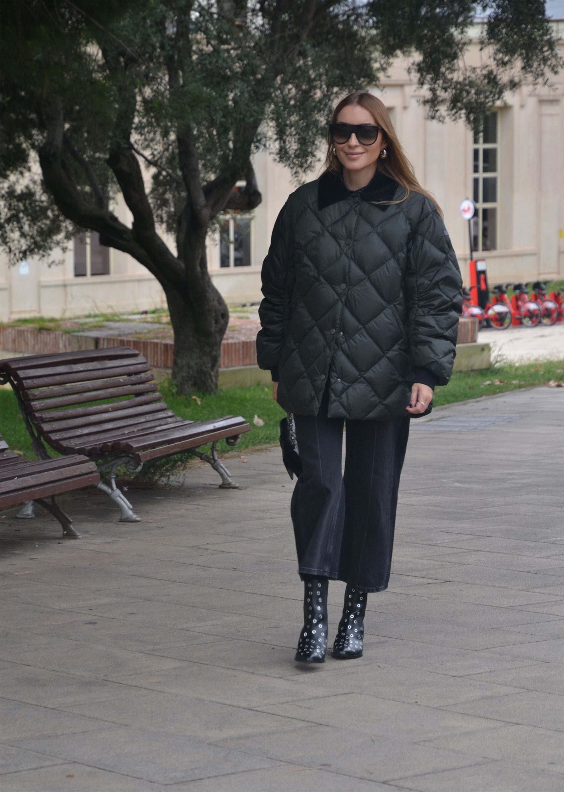 Mariona Planas walking in the city wearing the Lempelius Fia Barn Jacket, effortless winter street style.